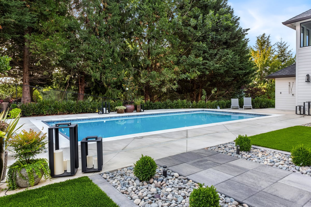 In-ground swimming pool with clear blue water in a backyard