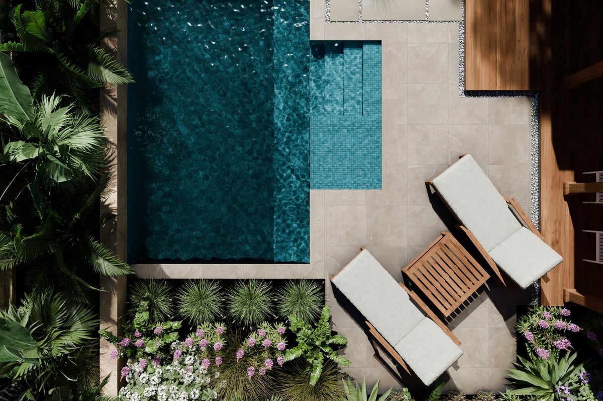 Aerial view of luxury swimming pool design and garden landscaping with tropical palms and natural stones